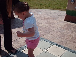 A child playing on the musical steps at the sensory playground at Fairmount park